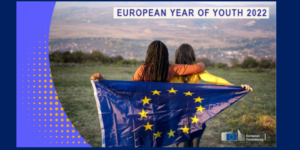 A poster of two people holding a EU flag. Above them there's the text "European Year Of Youth 2022"